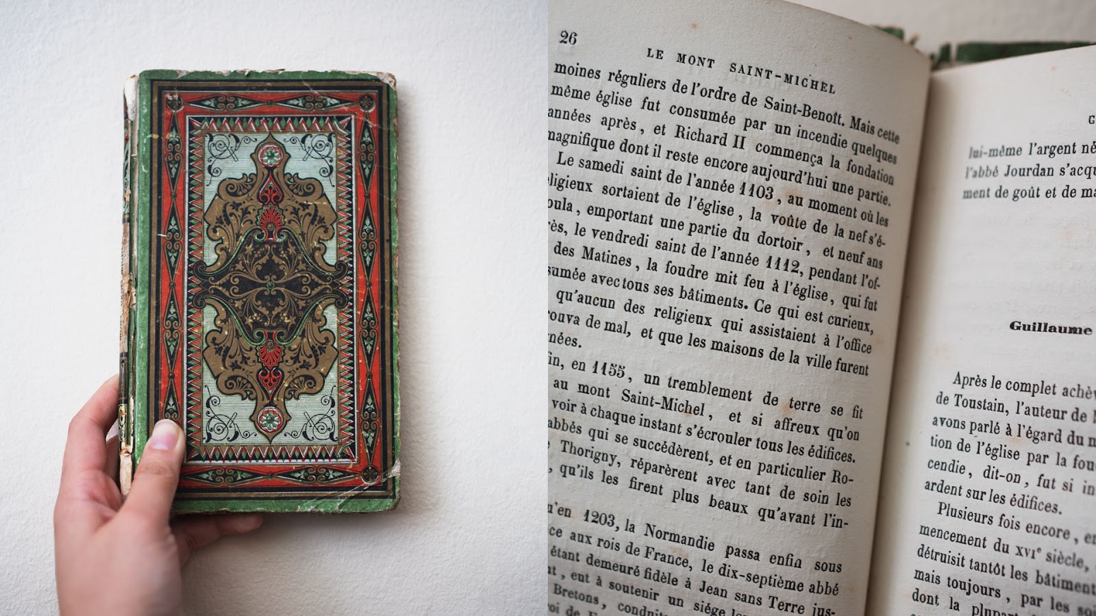 On the left, a hand holds a tattered, ornate book. On the right, a close up of page 26.